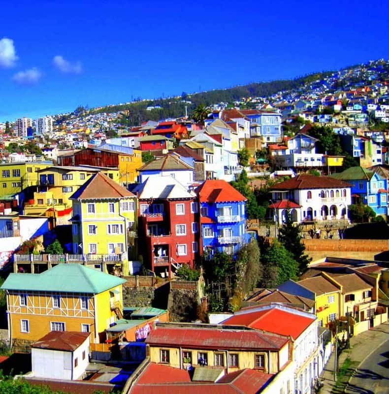 Yellow, blue and red house fronts stepping down a steep Valparaiso cerro